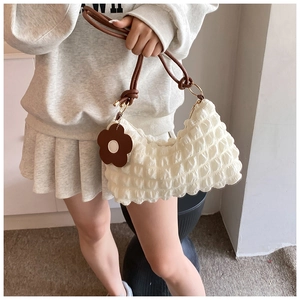 Chic pleated cloud bag with bubble texture and brown leather strap on model