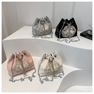 Detailed view of four Chinese style velvet bucket bags with floral embroidery and pearls