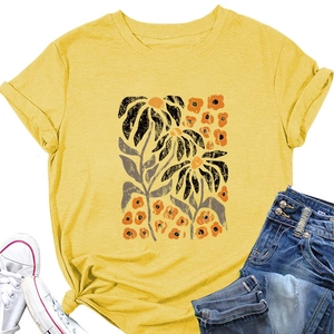 Detail of yellow T-shirt featuring abstract floral prints and cuffed short sleeves