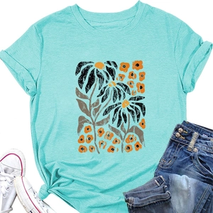 Flat lay of mint green floral T-shirt with vintage daisy print and denim shorts