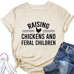 Flat lay of an apricot T-shirt with Raising Chickens slogan, jeans and white sneakers