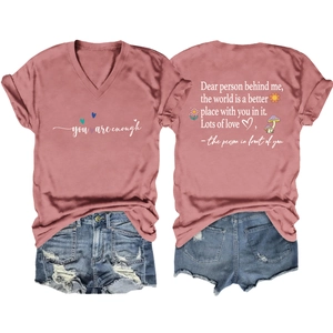 Flat lay of pink V-neck T-shirt with back quote print and ripped denim shorts set