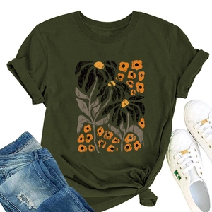 Detail of army green T-shirt featuring yellow floral print and stylish knotted hem design