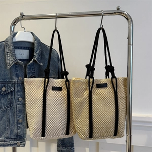 Large minimalist hollow woven straw tote bags in beige and natural brown colors