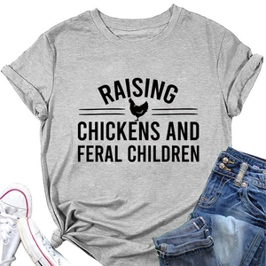 Flat lay of gray t-shirt with raising chickens slogan, sneakers and denim jeans