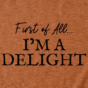 Macro detail of 'First of All... I'M A DELIGHT' print on soft caramel cotton t-shirt