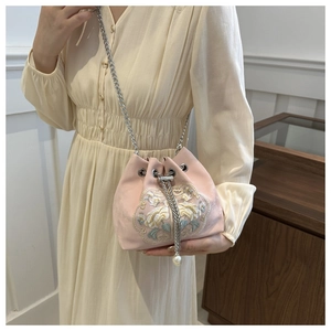 Pink silk bucket bag with floral embroidery, silver chain strap, and pearl tassels detail