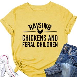 Flat lay of yellow cotton T-shirt featuring Raising Chickens slogan and rooster graphic
