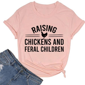 Flat lay of pink cotton T-shirt featuring Raising Chickens slogan and rooster graphic