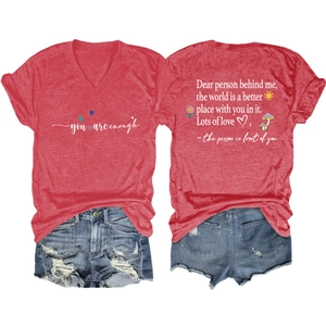 Flat lay of red V-neck T-shirt with 'you are enough' print and distressed denim shorts