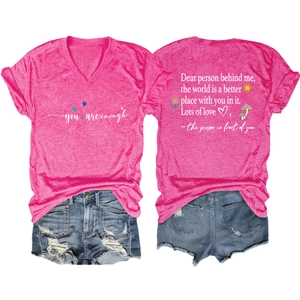 Flat lay of pink V-neck T-shirt and denim shorts with inspirational text detail