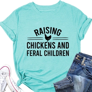 Flat lay of light blue T-shirt with Raising Chickens and Feral Children slogan