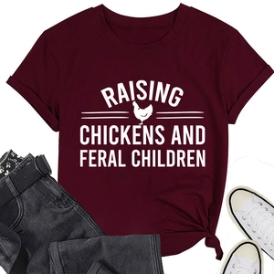 Close-up of burgundy t-shirt with raising chickens graphic print and knotted hem detail