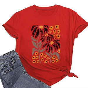 Detail of red floral T-shirt featuring a knot-tie hem and vintage botanical print