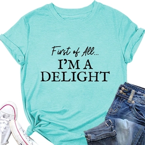 Flat lay of a turquoise women's T-shirt with 'First of All' text and knotted hem detail