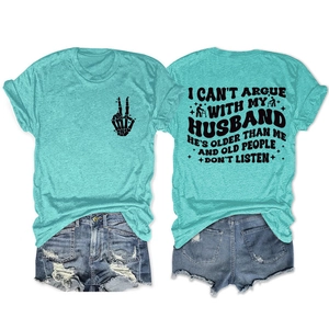 Flat lay of mint green t-shirt with humor slogan and distressed denim shorts outfit