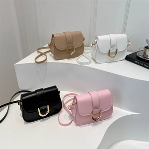 Chic saddle crossbody bags in four colors with gold horseshoe clasps on white steps