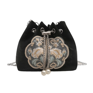 Elegant black velvet bucket bag featuring traditional Chinese floral embroidery and pearl chain