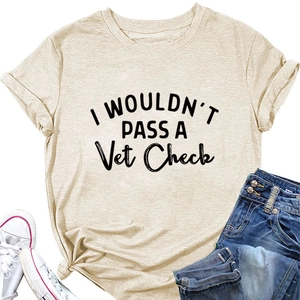 Flat lay of beige cotton T-shirt with I WOULDN'T PASS A Vet Check text and denim shorts