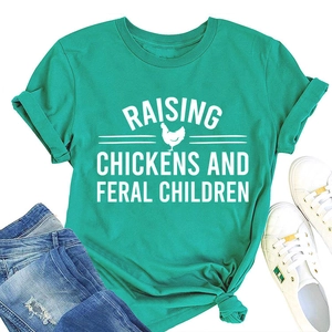 Flat lay of teal cotton T-shirt with Raising Chickens print and casual denim styling