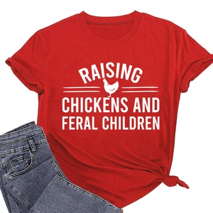 Detail of red cotton T-shirt featuring 'Raising Chickens' print and stylish hem knot