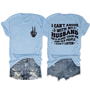 Flat lay of light blue T-shirt with back text and distressed denim shorts summer set