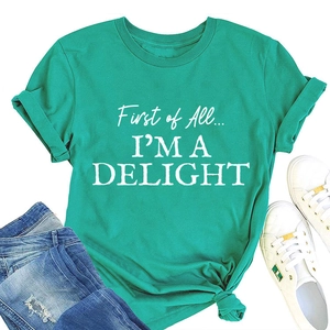 Flat lay of teal crew neck t-shirt with slogan and cuffed sleeves styled with jeans