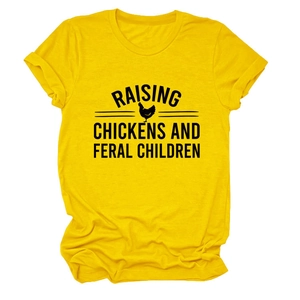 Detail of printed RAISING CHICKENS AND FERAL CHILDREN text on a yellow cotton t-shirt