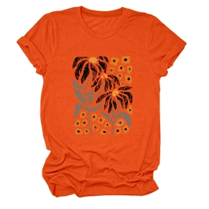 Detail of artistic floral print on an orange cotton crewneck short sleeve T-shirt