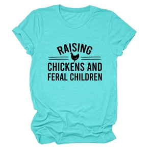 Close-up of raising chickens and feral children slogan and rooster print on teal tee