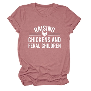 Close-up of pink crewneck T-shirt featuring Raising Chickens and Feral Children print