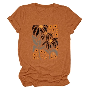 Detail of artistic floral woodcut print on vintage caramel orange cotton t-shirt