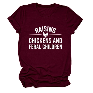 Close-up of Raising Chickens and Feral Children slogan on a burgundy cotton t-shirt