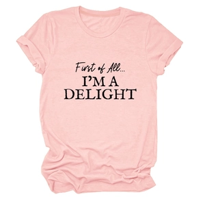 Detail of soft pink cotton t-shirt featuring 'First of All I'M A DELIGHT' black text print