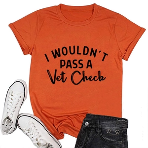 Flat lay of an orange cotton T-shirt with black letter print and casual summer styling