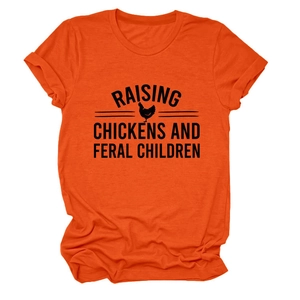 Detail of orange t-shirt featuring Raising Chickens and Feral Children slogan print