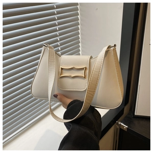 Detail of white PU leather underarm bag featuring minimalist gold buckle and sleek texture