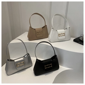 Minimalist leather underarm bags in four colors with gold buckles on a display stand