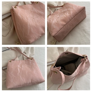 Detail view of pink pleated tote bag with fashion embossing and spacious interior