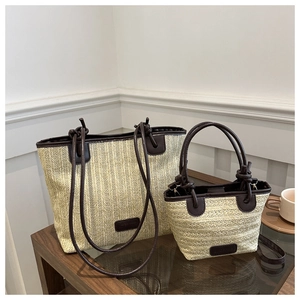 Detailed comparison of large and small woven straw tote bags with brown leather handles