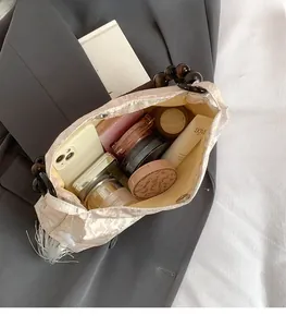 Detail view of jacquard fabric tote with wooden bead handle and spacious interior storage