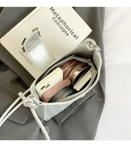 Detail view of silver crescent bag interior showing spacious storage for makeup and phone