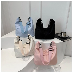 Detailed display of fashionable nylon tote bags in blue, black, white, and pink colors