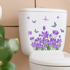 Purple floral wall stickers with butterflies applied to a white ceramic toilet tank