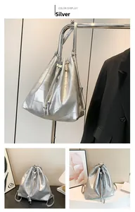 Detail view of silver bucket bag featuring geometric texture and drawstring closure system