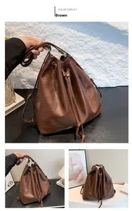Detail of brown bucket bag with geometric stitching and adjustable drawstring strap