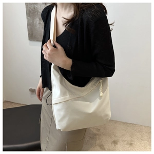 Stylish white nylon hobo bag shown as a crossbody on a model for daily commuting