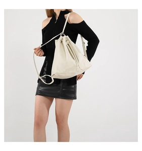 Detailed view of white drawstring bucket bag with soft premium leather texture