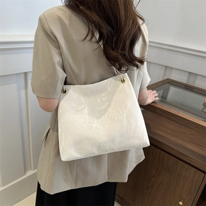 Minimalist white tote bag with cloud texture and embossed fashion text for casual use