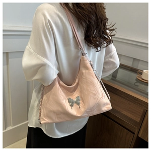 Detailed close-up of pink marble pattern shoulder bag with silver butterfly ornament